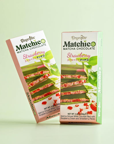 Two pieces of Beyoglu Matchico Matcha Chocolate- Matcha-infused white chocolate filled with raspberry cream and strawberry pieces